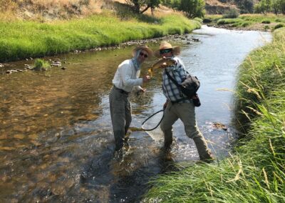 Wyoming ranch with a brown trout stream and happy fishermen