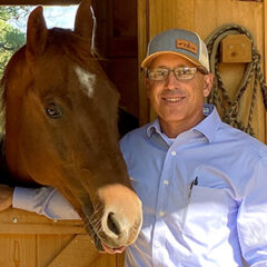 Portrait of Chase Brothers Land and Ranch broker and owner, Galen S. Chase with his horse Simon