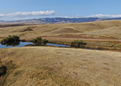 Mountain foothill land with views of the Bighorn Mountains, pond wildlife and prime exposure to the Bighorn National Forest