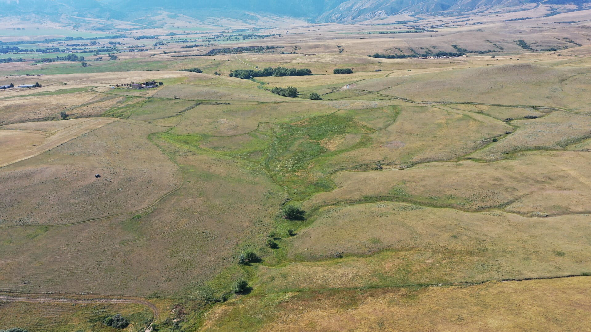 Mountain view ranch land overhead view from north