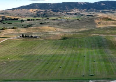 Clearwater West Big Horn, WY Equine Facility evening light south hay field 2nd cut bales and irrigaton